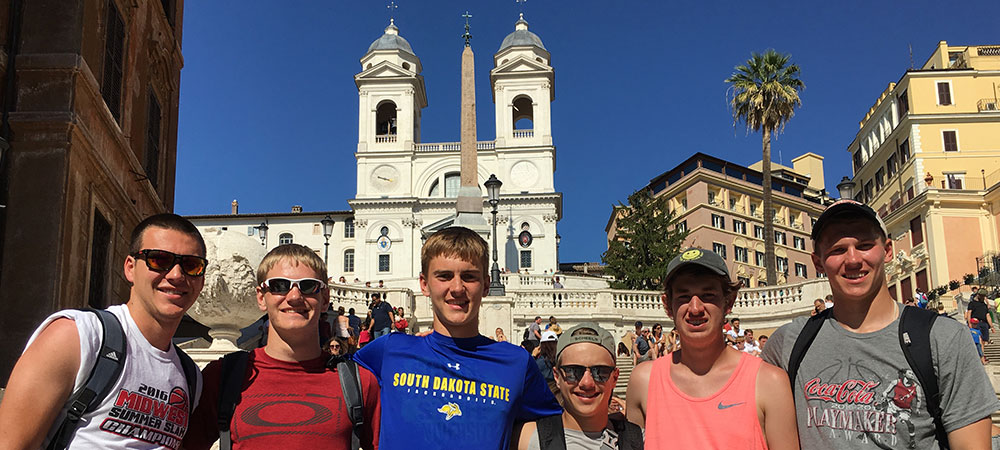 Group of Travelers with Mountains in background