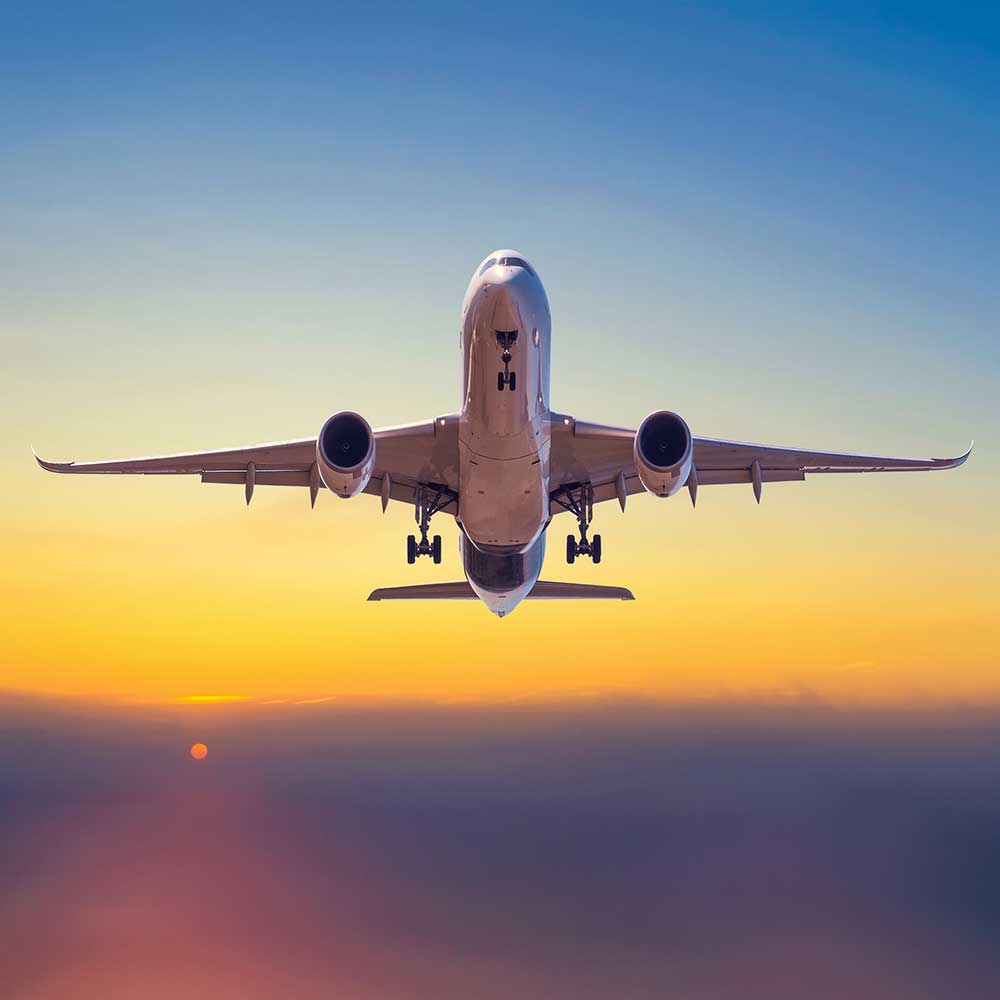 Airplane taking off in the sunrise